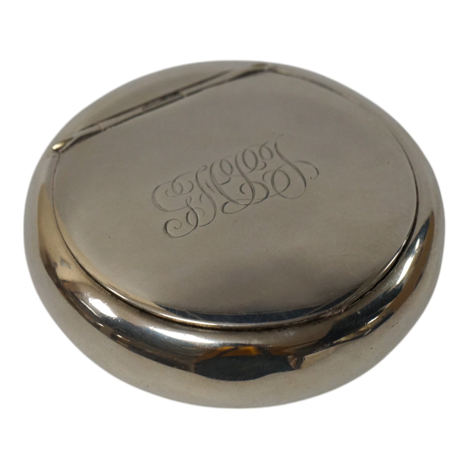 An Edwardian silver circular tobacco box, by A & J Zimmerman, Birmingham, 1905, 79mm, with engraved monogram. Condition - fair to good